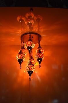 a chandelier hanging from the ceiling in an orange room