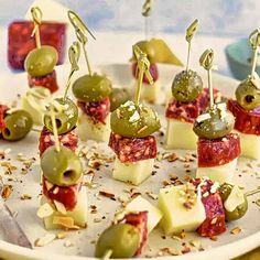 small appetizers with olives and cheese on a plate