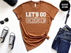 Lets Go Longhorns Shirt, Longhorns Volleyball, Longhorns Shirt, Longhorn Basketball, Longhorns School Mascot Shirt, Custom Longhorns Cheer 🚚 SHIPPING  &  PRODUCTION  TIME      ▶ Items typically shipped same day if color/size are in stock (feel free to inquire prior)      ▶ If not in stock, shipping/production time is typically 1-5 business days      ▶ Please contact us if you are in a rush! 🎆 BACK  UPGRADE      ▶ If you would like to add text to the back, please go to the listing below and add to cart      ▶ https://www.etsy.com/listing/1222039886 👕 MATERIALS      ▶ Heather Colors are cotton/polyester blend (super comfy and soft)      ▶ Bella Canvas brand shirts - Size/color chart(s) available in photos      ▶ Soft and high-quality fabric, pre-shrunk, tapered shoulder-shoulder; Side sea Longhorns Volleyball, Mascot Shirt, Lubbock Tx, Brand Shirts, School Mascot, Lets Go, Add Text, Branded Shirts, Color Chart