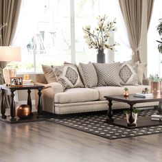 a living room filled with lots of furniture next to a large white couch and coffee table