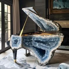 a grand piano in the middle of a room with a painting on the wall behind it