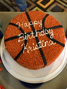 a birthday cake for a basketball player on a table with scissors and other items in the background