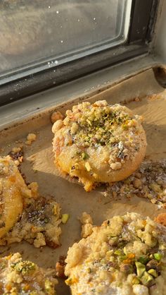 some food that is on top of a baking sheet in front of a oven door