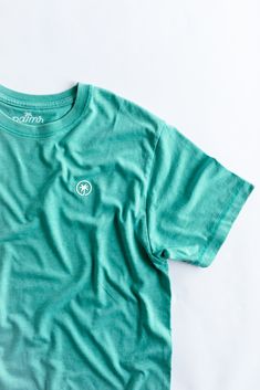 Feel the ultimate blend of comfort and style with The Juan and Only Signature Tee in Saltwater. This men’s signature tee features a super soft vintage wash, designed to become your go-to shirt for any casual occasion. Crafted from a high-quality blend of 52% polyester and 48% ringspun cotton, this 5.7oz cotton blend t-shirt offers a lightweight yet durable feel. The subtle saltwater color, paired with the signature Palmr Palm Tree logo, brings a touch of elegance to your everyday style. Slip int Palm Tree Logo, Tree Logo, Tree Logos, S Signature, Everyday Style, Palm Tree, Everyday Fashion, Classic Style, Cotton Blend