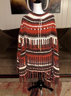 Vintage * Southwestern* Alpaca Fabric * Brown/Beige * One Size * Fringe * Geometric Design * Poncho. Real alpaca fiber is one of the warmest & soft in the world.  Details:  1.) One size fits most adults  2.) Pull string to adjust around collar  3.) Shoulder to shoulder: 22" inches  4.) Waist: 70" inches  5.) Hip: 80" inches  6.) Shoulder to hem: 32" in. 7.) Chest: 40" inches Thanks for looking!! Oversized Brown Bohemian Sweater, Brown Fringe One Size Poncho, Brown One Size Poncho With Fringe, One Size Brown Fringe Poncho, One Size Bohemian Sweater With Fringe, One Size Bohemian Fringe Sweater, Bohemian Alpaca Outerwear For Fall, Brown Fringed Poncho For Fall, Brown Fringe Poncho For Fall