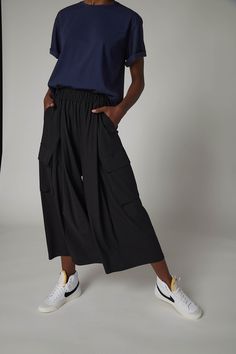 These skirt pants is a fresh take on the cargo pants. Pair this gorgeous, draped styling piece with a basic white tee for an easy weekend look, or blouse for a fashion-forward evening look Casual Wide Leg Cargo Skirt With Pockets, Casual Wide-leg Cargo Skirt With Pockets, Versatile Summer Bottoms With Multiple Pockets, Summer Workwear Parachute Pants With Cargo Style, Summer Cargo Style Parachute Pants For Workwear, Summer Workwear Cargo Skirt With Side Pockets, Versatile Summer Cargo Pants With Side Pockets, Summer Workwear Parachute Pants With Cargo Pockets, Chic Baggy Cargo Pants With Cargo Pockets