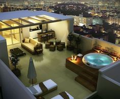 an aerial view of a living room and hot tub in the middle of a city at night