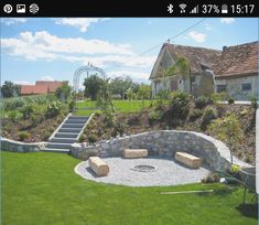 a stone fire pit in the middle of a yard with steps leading up to it