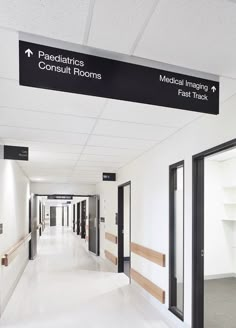 an empty hospital hallway with black and white signs