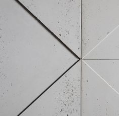 the corner of a white tile wall that has been grouted