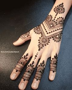 the hand is decorated with henna designs