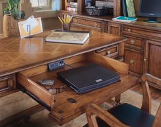 a wooden desk with a laptop on it