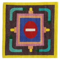 a colorful rug with an abstract design in the center and a red circle on it