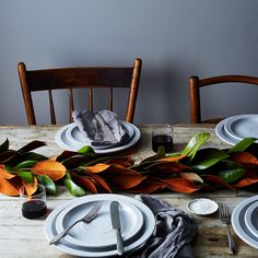 the table is set with plates and silverware