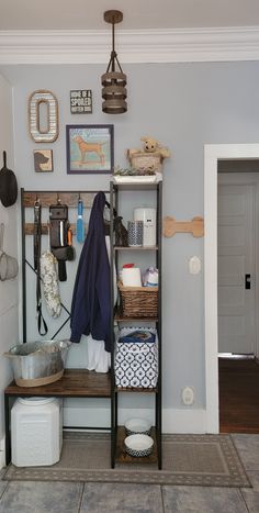 a dog laying on the floor next to a shelf