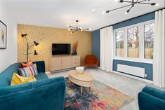 a living room filled with furniture and a flat screen tv on top of a wooden stand