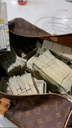 a purse full of money sitting on top of a table