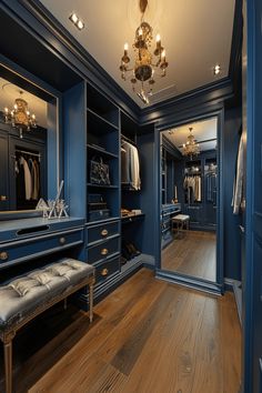 a walk in closet with blue walls and wooden floors