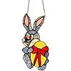 an ornament shaped like a rabbit holding a candy