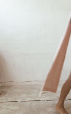 a person standing in front of a white wall