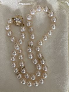 Gorgeous vintage Akoya pearl necklace, 17.5" with diamond spacers, 13 mm diamond clasp all in 14k. The pearls are 8-8.5 mm and display high luster and lovely ivory pink coloring. Well matched with smooth skins. Diamonds on both sides of round clasp. Beautiful vintage pearl diamond necklace. Comes in lovely cream suede drawstring pouch. Classic Diamond Pearl Bracelet For Formal Occasions, Vintage Gold Akoya Pearl Necklace, Vintage Akoya Pearl Necklace For Formal Occasions, Formal Fine Jewelry Pearl Necklace With Round Beads, Formal Round Beads Pearl Necklace Fine Jewelry, Vintage Akoya Pearl Drop Necklace, Vintage Single Strand Akoya Pearl Jewelry, Exquisite Pearl Necklace With Diamond Accents For Formal Events, Round High Luster Pearl Necklace For Anniversary