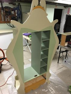 a cabinet is being constructed in the shape of a horse head with shelves on each side