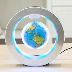 a blue and white light up globe sitting on top of a table