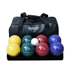 an assortment of boccquets and balls in a black case on a white background