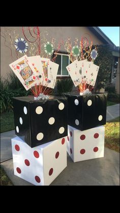 two black boxes with red and white polka dots on them sitting in front of a house