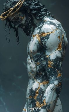 a man with long black hair and gold paint on his body is standing in front of a dark background