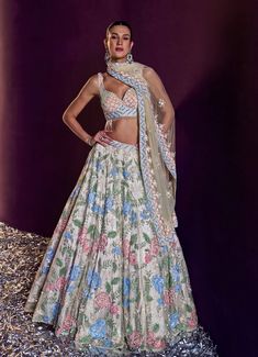 This exquisite Ivory Multi Colour Sequins Embroidered Lehenga Set is a stunning blend of elegance and modern charm. Crafted from soft net fabric, the ivory lehenga is adorned with intricate floral motifs and features an array of multi-coloured sequins, crystals, and bugle beads that shimmer with every movement. The delicate embroidery enhances the luxurious feel of the fabric, creating a look that's both ethereal and sophisticated. Paired with a beautifully designed blouse and completed with a matching dupatta with embellished details, this ensemble is perfect for the bride or bride-to-be on her special day. Composition : Lehenga, Blouse and Dupatta - Net Care: Dry Clean Only and Vacuum Storage This product can be customized for sleeves, blouse style and colour Delivery : 6-8 weeks as the Cream Bollywood Lehenga With Floral Embroidery, Traditional Drape Sets With Floral Embroidery In Cream, Cream Sets With Floral Embroidery And Traditional Drape, Festive Off White Lehenga With Floral Embroidery, Festive Cream Lehenga With Floral Embroidery, Off White Floral Embroidered Sharara For Reception, Off White Floral Embroidered Traditional Wear For Reception, Off White Traditional Wear With Floral Embroidery For Reception, Festive Cream Choli With Floral Embroidery