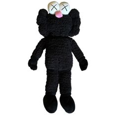 a black teddy bear with two eyes and one eyeball in the shape of a cat