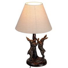 a table lamp with two deers on it