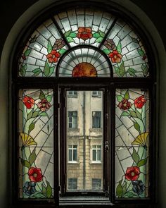 a stained glass window with flowers on it