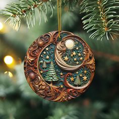 an ornament hanging from a christmas tree decorated with stars and crescent moon designs