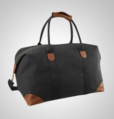 a large black bag with brown leather handles