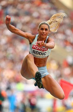 a woman jumping in the air with her legs spread