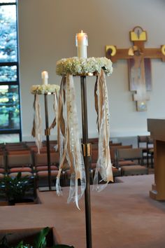 an altar decorated with flowers and candles in front of the alter at a wedding ceremony