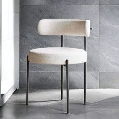 a white chair sitting on top of a tiled floor