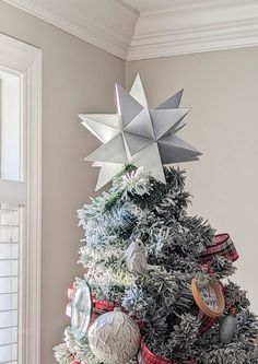 a christmas tree decorated with silver and red ornaments