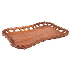 a wooden tray that is shaped like an oval shape with holes in the center and sides