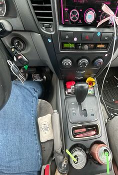 the interior of a car with various items in it