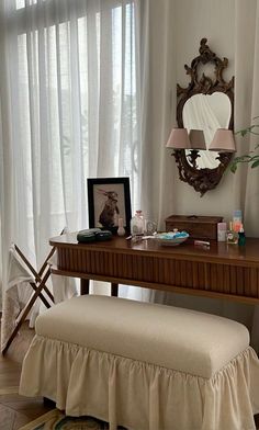 a desk with a bench and mirror in front of it