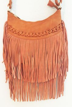 This casual crossover bag is your next best friend! With a top zip closure and back zip pocket, this small bag can easily fit all your everyday items in it. The front features a faux leather cross stitch detail with a fun boho suede fringe that hangs about 10" long. The shoulder bag has a 45" strap and interior zip pocket. So grab a girlfriend and go exploring in the 'City of Austin' with this must have accessory to go with your favorite denim. Available in camel. Vegan leather and suede. 9" x 8 Trendy Satchel Bag With Fringe, Trendy Fringed Satchel Bag, Trendy Fringe Satchel Bag, Chic Rectangular Saddle Bag For Shopping, Trendy Brown Saddle Bag For Shopping, Trendy Rectangular Bag With Fringe, Trendy Fringed Satchel Shoulder Bag, Trendy Fringe Satchel Shoulder Bag, Chic Saddle Bag For Shopping