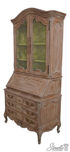 an old wooden desk with glass doors and drawers