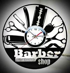 a barber shop clock with scissors and razors on it