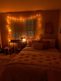 a bedroom with lights strung from the ceiling