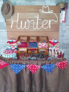 a table topped with lots of cake and cupcakes next to a sign that says return