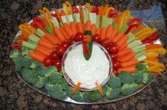 a platter filled with vegetables and dip