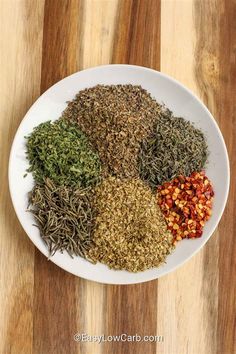 various spices are arranged on a white plate